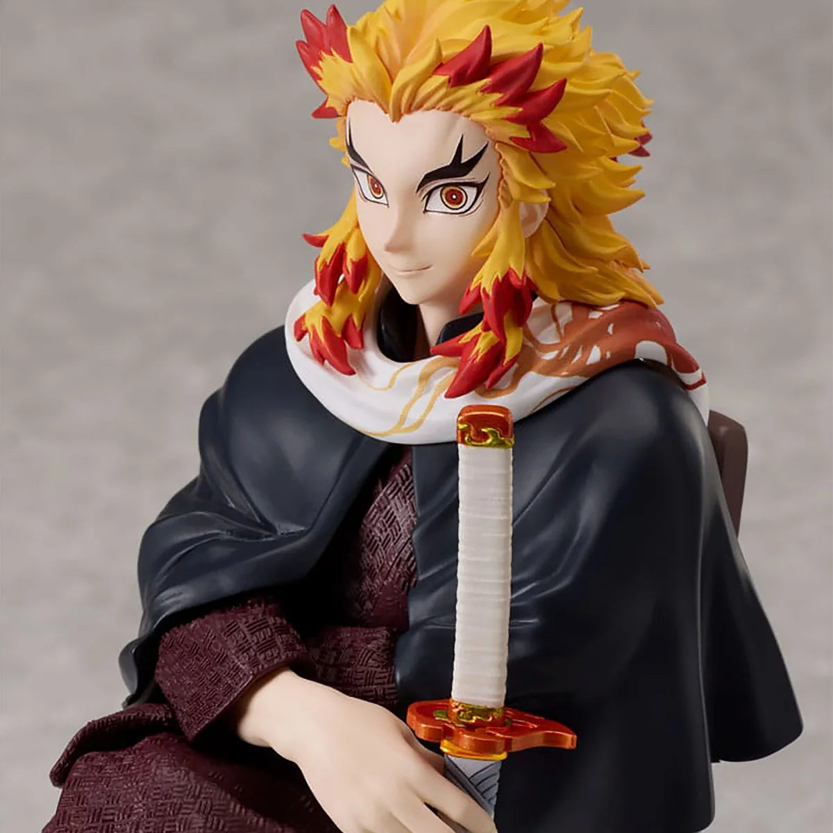Close-up of Kyojuro Rengoku Aniplex figure showing his face and flame-colored hair